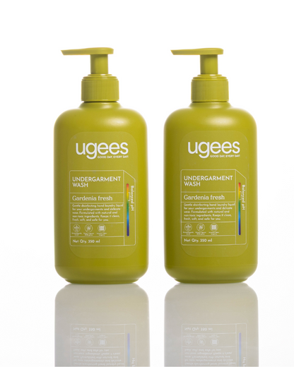 Two bottles of Ugees Undergarment Wash in Gardenia Fresh scent, shown side-by-side on a white reflective surface.