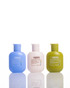 Three Ugees Underwear, swimwear and delicates care bottles lined up on a reflective white surface against a white background. The bottles are light blue, off-white, and olive green, with white caps.